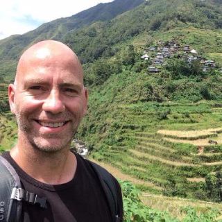 Syl Primeau climbing rice terraces in Batad, Philippines